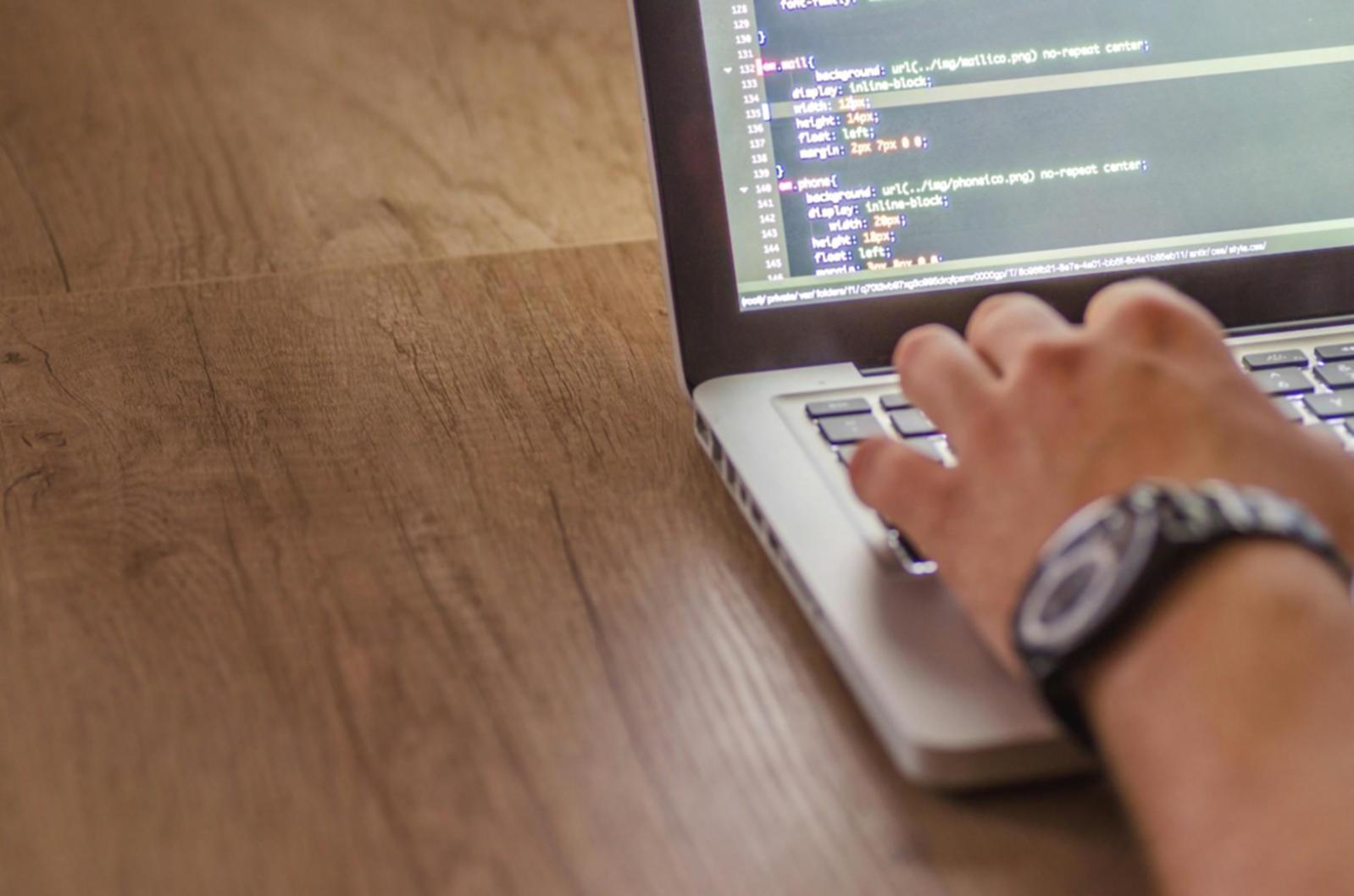 Graduate working on professional database project in modern office environment